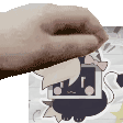 a close up of a person 's hand holding a sticker .