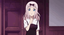 a girl with pink hair and blue eyes is standing next to a door