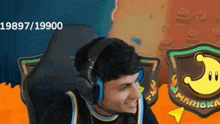 a man wearing headphones is sitting in a chair in front of a mario game .