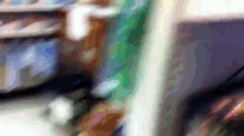 a blurry picture of a person standing in front of a shelf