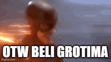 a blurry picture of a person with the words otw beli grotima written below them