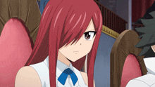 a girl with red hair is wearing a white shirt with a blue bow