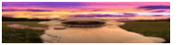 a blurry picture of a lake with a sunset in the background