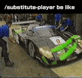 a green and gray race car with the number 0 on the side