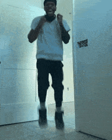 a man wearing headphones is jumping in the air