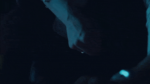 a man wearing a watch is holding another man 's arm