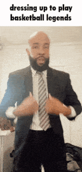 a man in a suit and tie is dressing up to play basketball legends .