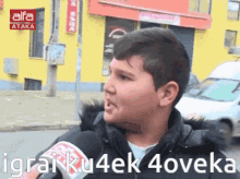 a young boy is talking into a microphone and the words igrai ku4ek 4oveka are on the screen behind him