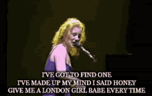 a woman singing into a microphone with the words i 've got to find one on the bottom