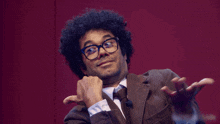 a man wearing glasses and a suit says what ya gonna do