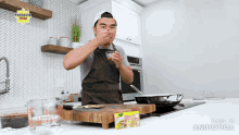 a man in an apron is cooking in a kitchen with a knorr box on the counter