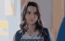 a girl with a backpack looks to the side