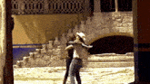 a couple dancing in front of a building with stairs
