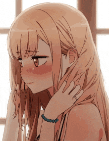 a close up of a blonde anime girl with long hair and a bracelet on her wrist .