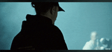 a man in a black hoodie with the word barrier on it