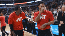 two basketball players wear red shirts that say fit