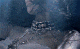 a close up of a woman 's face underwater with her eyes closed
