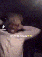 a man with blonde hair is covering his face with his hands and a tiktok video .
