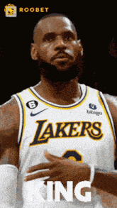 a basketball player for the lakers is wearing a white jersey