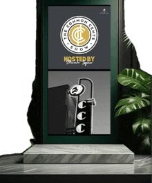 a poster for the common cents show is displayed on a marble podium