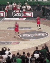 a basketball game is being played in front of a banner that says 3toixima
