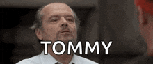 a bald man with a beard is wearing a white shirt and tie .