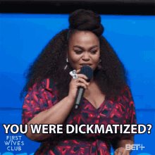 a woman holding a microphone with the words " you were dickmatized "