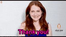 a woman with red hair says thank you in pink
