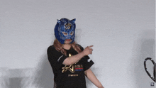 a woman wearing a mask and a t-shirt that says t4dom