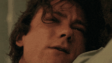 a close up of a man 's face with a sad look on his face