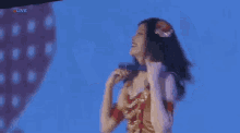 a woman is singing into a microphone with the word live on the bottom