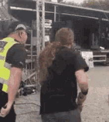 two men are standing next to each other in front of a stage .