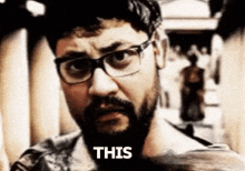 a man with glasses and a beard says this on his face