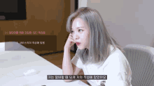 a woman is sitting at a table with a mouse and a sign that says ' sf '