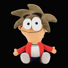 a stuffed cartoon character with big eyes is sitting down