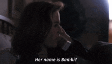 a woman laying on a bed with the words her name is bambi behind her