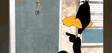 a cartoon of a duck pointing at the number 3 on a door