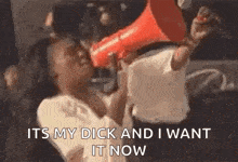 a woman is holding a megaphone in her hand and screaming into it .
