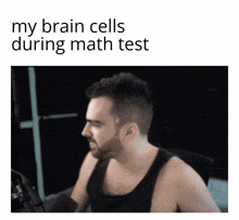 a man sitting in front of a microphone with the words " my brain cells during math test " on the bottom