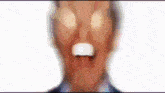 a blurry picture of a person 's face with a light behind them