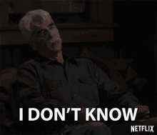 a man with a mustache is sitting in a chair and says i don 't know