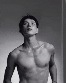 a man without a shirt is looking up at the camera