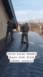 two men are working on the roof of a building with a caption that says " canim kocam damdan "