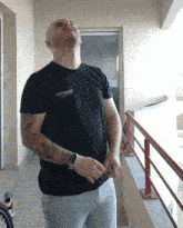 a man wearing a black shirt that says balenciaga