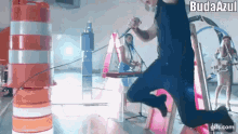 a man is jumping in the air while singing into a microphone while a band plays behind him