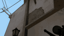 a sniper scope is mounted on a pole outside of a building