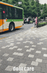 a green and white bus is driving down a brick sidewalk with the words dont care below it