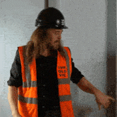 a man wearing a hard hat and a vest that says the old vic