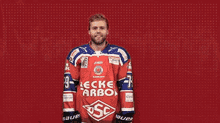 a hockey player wearing a red and blue jersey that says beckel carbon