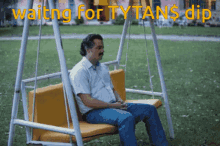 a man is sitting on a swing with the words waiting for tytans dip written above him